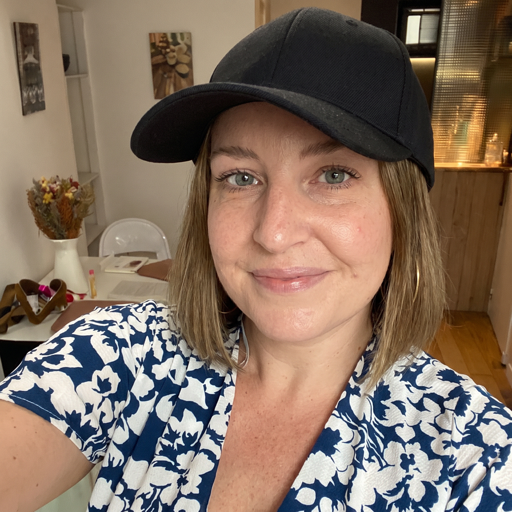 AI-generated illustrative scene 3: person wearing a black cap at home.